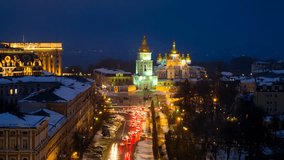 Kyiv, Ukraine. A video of night in Kyiv, Ukraine, with a view of the St Michaels Golden - Domed Monastery and traffic on a winter day with a dark sky. Time-lapse at sunset with illumination, zoom in