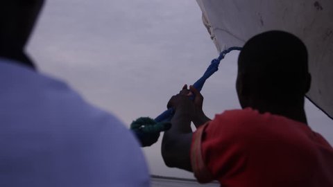 African guys sailing (Red.Tech) (Slowmo)