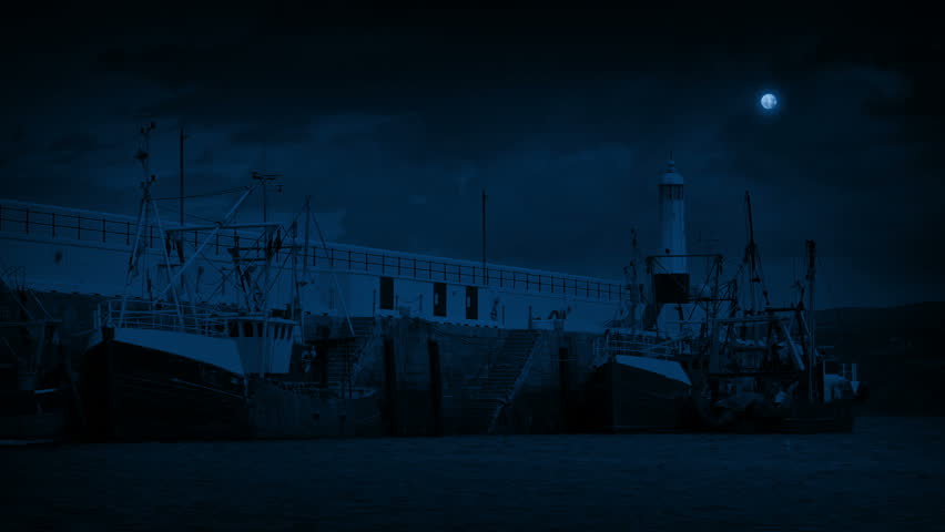 Weathered Fishing Boats In The Harbor At Night