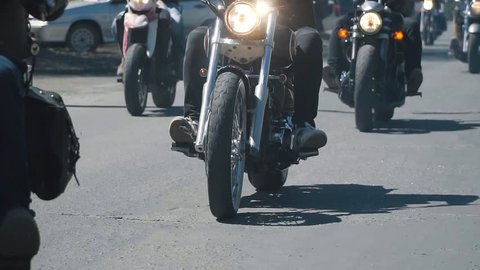 many subculture bikers group ride on the track on a Sunny summer day on custom motorcycles, a large-scale action of motorcyclists