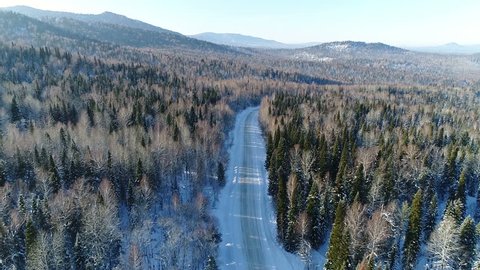 Aerial View. Flight over the Winter Mountain Road. Altai Siberia. Altai is situated in the very center of Asia at the junction of Siberian taiga, steppes of Kazakhstan and semi-deserts of Mongolia