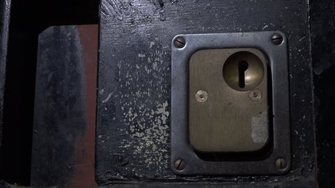 Prison door slams shut, white light from window obscured by closing of jail door with close up of lock