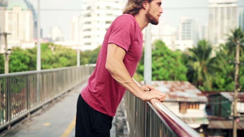 Runner warming up for a run. White male stretching in walk bridge ready for his run.