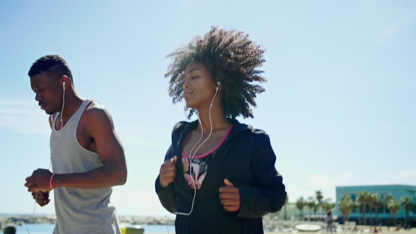 Young happy black couple excercising outdoors