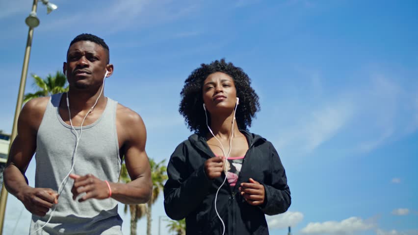 Young happy black couple excercising outdoors