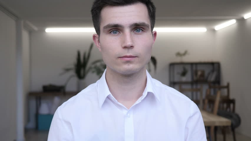 Portrait of Smiling Businessman Looking at Camera