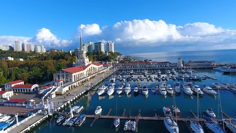 A beautiful summer Aerial Flight over the city of Sochi and a seaport early in the morning 4k