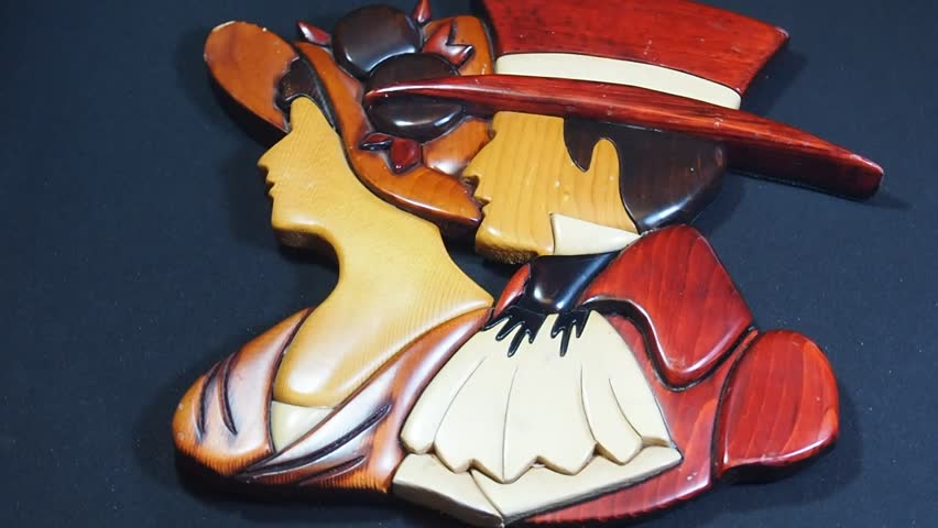 Wooden artwork of man and woman face. Classic and retro style background. 
