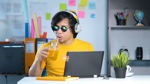 Working From Home. Young Man Working and Enjoying Music on Summer Vacation Season at Office 4k