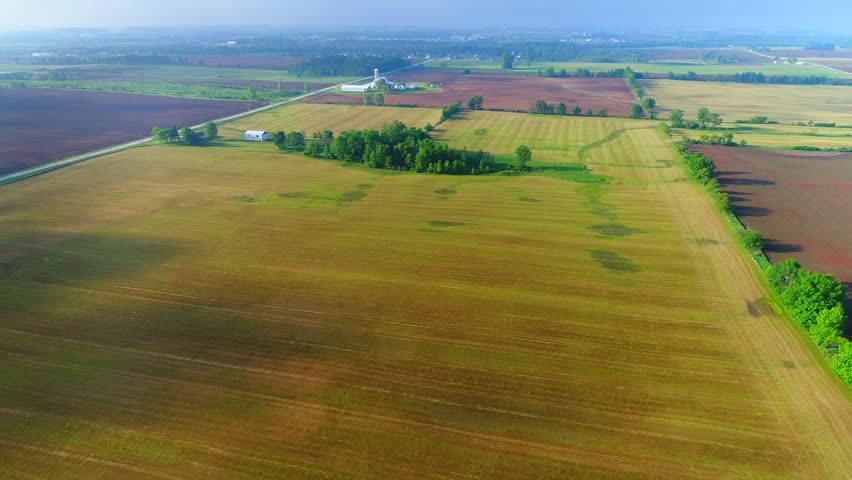 Time Lapse flyover of misty rural Wisconsin Landscape with moving cloud shadows.
