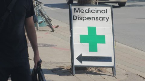 MEDICAL MARIJUANA DISPENSARY, TORONTO, CANADA - CIRCA JUNE 2018: Store fronts, shops, and sign closeups of weed dispensaries across Toronto. (For real-time playback re-conform to 60p).
