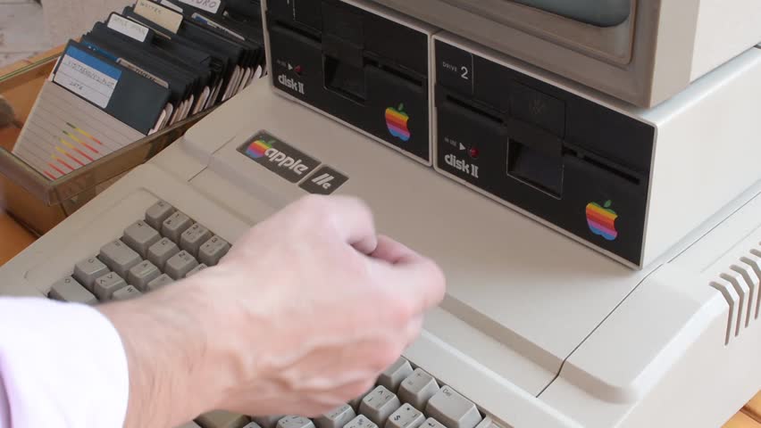 Cisternino, Italy - April 29, 2018: Aged Apple computer and hand change floppy and then  typing on keyboard | Shutterstock HD Video #1012790555