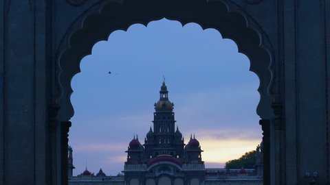 Evening view of birds flying over Mysore palace through the entrance gate