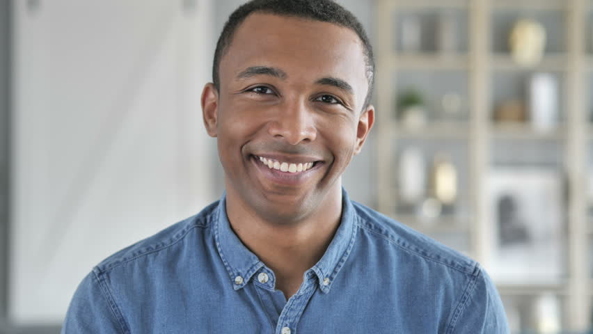 Portrait of Smiling Young African Man Looking at Camera | Shutterstock HD Video #1012793039