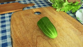 Time Lapse of Man Slicing Cucumber on a Kitchen Table. 4K Ultra HD 3840x2160 Video Clip