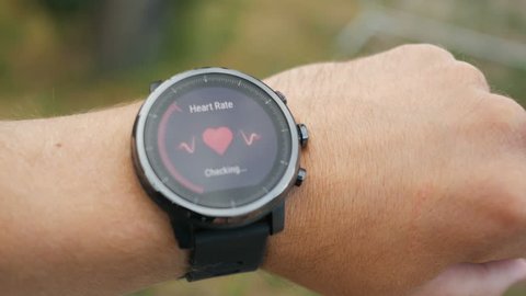 Checking the heart rate by smart watch. Smartwatch. Touching screen. Pulse checking. heart rate monitor