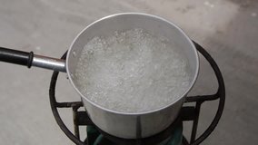 Boiled water in the pot with close up view and PAL footage clip