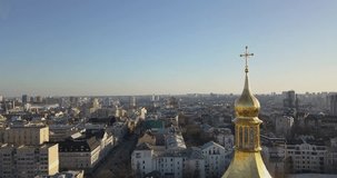 A bird's eye view, panoramic video from the drone in 4K to the golden dome Saint Sophia's Cathedral, Maidan Nezalezhnosti, left bank of city Kiev, Ukraine.