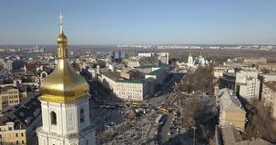 A bird's eye view, panoramic video from the drone in 4K to the Saint Sophia's Cathedral, Sofiyivska Square, left bank of city in the city of Kiev, Ukraine. People on the square on Easter days.