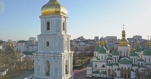 A bird's eye view, panoramic video from the drone in 4K to the Saint Sophia's Cathedral-the bell tower and main building in the city of Kiev, Ukraine against a bright sun.