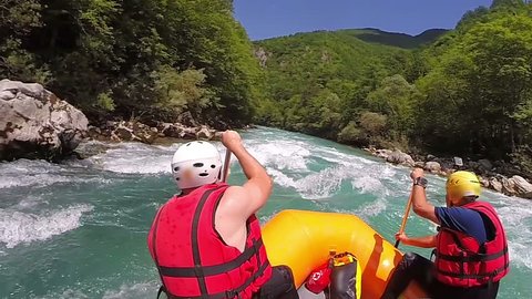 People in boat enjoy on whitewater rafting trip on Tara river in Montenegro, slow motion