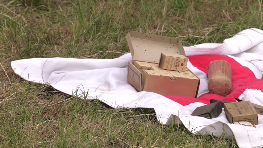 A military equipment in the background. First aid. Battlefield from the Second World War. 4K, UHD, 50fps, Panning, Closeup 
