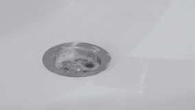 Close-up wiping bathroom sink drain hole 4K footage