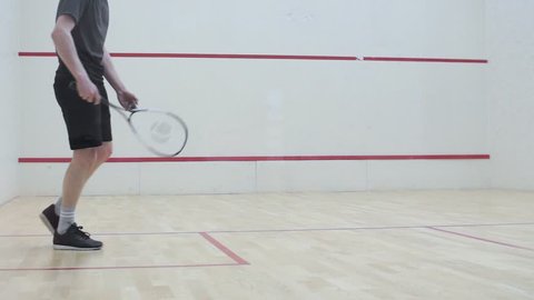 young man kneads on the sports ground before the competition with the partner in the squash game. corporate sport. mobile game with racket and ball