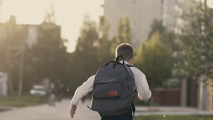 CU, Slow motion, Back view shot: Student runs home from school | Shutterstock HD Video #1012835351
