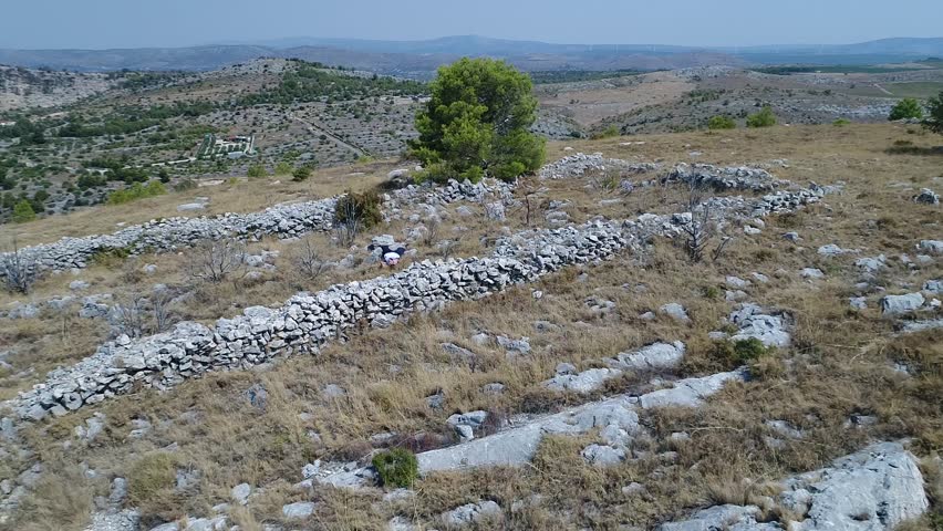 Young man climbing a hill at the coast of Croatia