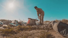 dirty homeless man at the lifestyle dump slow motion video. homeless roofless person looking for food in a dump. refugee homeless illegal immigration poverty concept
