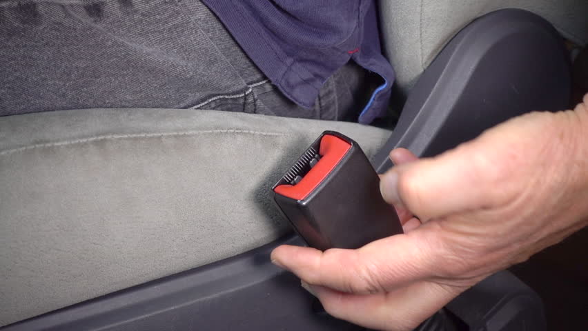 Slow motion close shot of a man’s hands fastening a vehicle seat belt. Royalty-Free Stock Footage #1012840457