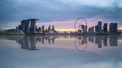 4k UHD time lapse of beautiful sunset at Marina Bay Singapore city skyline with reflection effect. Zoom in