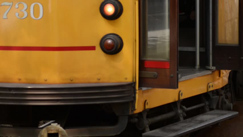tram stop with passengers coming and going and doors closing