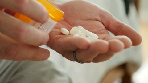 A dolly shot of a man nearly dead on the floor after a prescription drug overdose