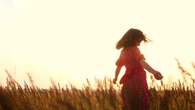 slow motion video. beautiful girl whirls in the field hands in the hand silhouette at sunset sunlight. woman concept freedom joy lifestyle happiness travel