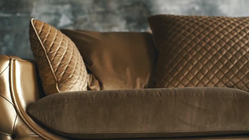 Luxury golden sofa on a loft background Royalty-Free Stock Footage #1012864697