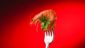 Shrimp. Fresh Prawn on a fork rotated on Red Background. Seafood, preparing healthy gourmet food, healthy eating, cooking, diet, nutrition concept. Slow motion 4K UHD video