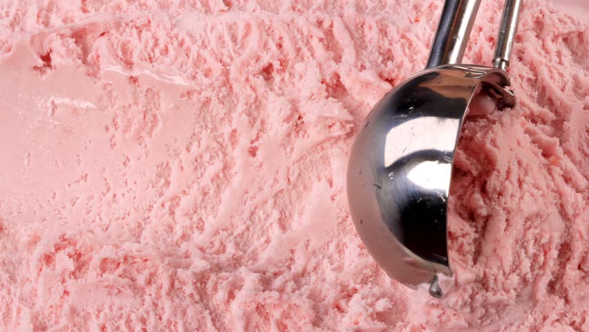Strawberry ice cream scooped out of container with a utensil. Closeup 4k | Shutterstock HD Video #1012870661