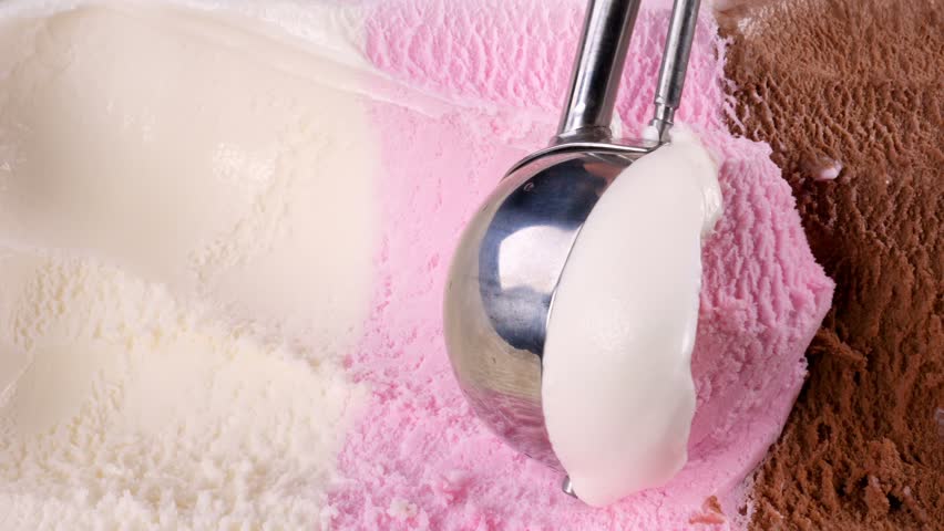 Vanilla strawberry chocolate ice cream scooped out from container with a spoon. Closeup 4k | Shutterstock HD Video #1012870715