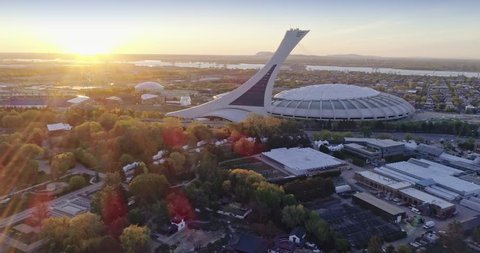 MONTREAL, QUEBEC, CANADA, 22 May 2018. AERIAL: Flying over the Montreal Olympic Stadium at sunrise. It is located at Olympic Park, uses in the 1976 Olympics, in the Hochelaga-Maisonneuve district 