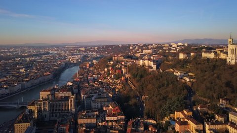 lyon city aerial view at sunrise flying from center to notre dame basilica