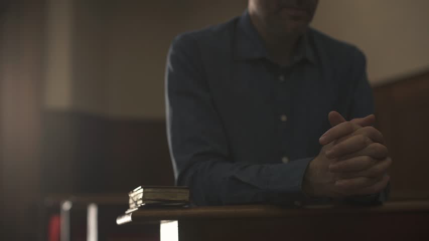 Devote man kneeling in the Church alone and praying, he is meditating with hands clasped: Christianity, religion and faith concept | Shutterstock HD Video #1012877225