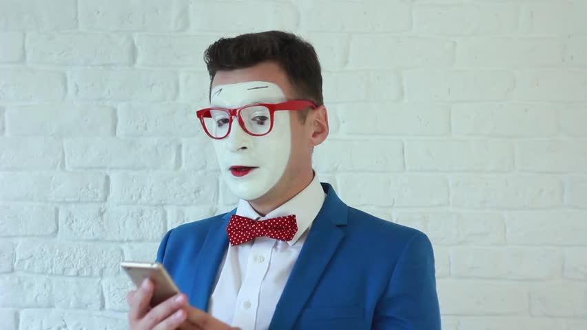 mime businessman in suit with phone in hand