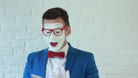 happy mime with phone in hand