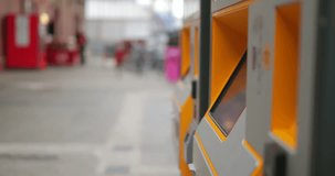Side view of an unrecognisable person using a ticket machine to buy a ticket for the train.
