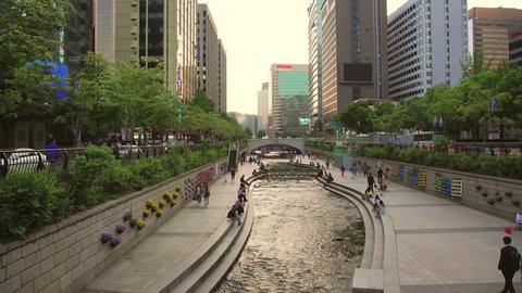 Seoul, South Korea - June 3, 2018: People walking along Cheonggyecheon stream in Seoul. Cheonggyecheon stream is a 10.84 km - long stream flowing from Gwanghwamun to Dongdaemun