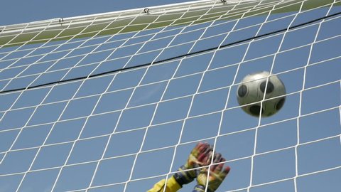 The goalkeeper could not catch the ball at goal. Soccer Ball flies into Goal Net. Goal scored during the soccer game