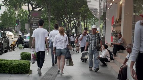 Kuala Lumpur, Malaysia - Circa 2018 : Group of working people walking in front a shopping mall