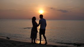 Romantic dances of a couple in love on the beach against a beautiful sunset. HD, 1920x1080, slow motion - Powered by Shutterstock - Get 15% off with code: PIKWIZARD15